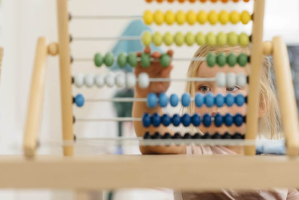 Early Learning at Quintilian School | Closeup of Young child using abacus